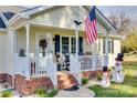 Inviting front porch with rocking chairs and American flag at 518 Ponderosa Dr, Fort Mill, SC 29707