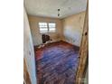 Small bedroom with hardwood floors and dirty walls at 934 Pebble Rd, Rock Hill, SC 29730