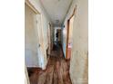 Long hallway with dirty hardwood floors needing refinishing at 934 Pebble Rd, Rock Hill, SC 29730