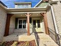 Inviting front porch with wooden posts and wrought-iron railing at 959 Tamary Way # 29/30, Landis, NC 28088