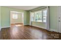 Spacious living room with hardwood floors and view into dining area at 1969 Woodland Dr, Charlotte, NC 28205