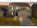 Two-story house with attached garage and landscaped lawn at 5021 Markfield Ln, Monroe, NC 28110