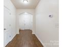 Light-filled entryway showcasing hardwood floors and interior doors at 8127 Paw Club Dr, Charlotte, NC 28214