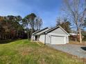 Newly constructed home with gray siding, a two-car garage, and a well-manicured lawn at 179 Harley St, Wadesboro, NC 28170