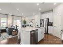 Modern kitchen with white cabinets, stainless steel appliances, and an island at 2043 Old Rivers Rd, Concord, NC 28027