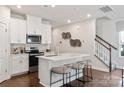 Open concept kitchen with white cabinets, island, and stainless steel appliances at 2043 Old Rivers Rd, Concord, NC 28027