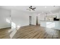 Open concept living room with hardwood floors and views into the kitchen area at 209 Westover Ave, Kannapolis, NC 28081