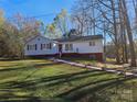 Ranch home with gray siding and red accents on a spacious lot at 7154 Woodcock Trl, Stanley, NC 28164