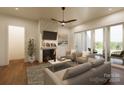Living room with fireplace, hardwood floors, and sliding doors to patio at 154A Lookout Dam Rd, Statesville, NC 28625