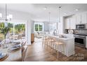 Open concept kitchen with white cabinets, island, and breakfast area at 3037 Finchborough Ct # 222, Charlotte, NC 28269