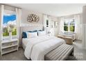 Bright main bedroom with plush bed, sitting area, and large windows at 3037 Finchborough Ct # 222, Charlotte, NC 28269
