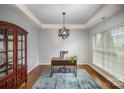 Home office with hardwood floors, a desk, and a large window at 10319 Dominion Village Dr, Charlotte, NC 28269