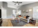 Light beige couch, wood-look floors, and a ceiling fan at 1707 Clemmon Sanders Cir, Rock Hill, SC 29732