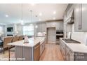 Gray kitchen cabinets, quartz countertops and island, stainless steel appliances at 9927 Cask Way, Huntersville, NC 28078