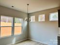 Bright dining area with chandelier and three windows offering natural light at 1066 Bull Dog Ln, Wingate, NC 28174