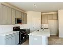 Modern kitchen with gray cabinets, stainless steel appliances, and white quartz countertops at 1066 Bull Dog Ln, Wingate, NC 28174