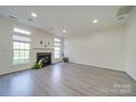 Bright living room with hardwood floors and fireplace at 11628 Eastwind Dr, Charlotte, NC 28273