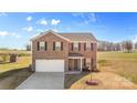 Two-story home with a brick facade, attached garage, and front yard at 109 Vintage Woods Ln, Shelby, NC 28150