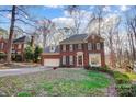 Two-story brick home with a nicely landscaped lawn at 15001 Chilgrove Ln, Huntersville, NC 28078