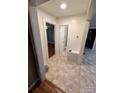 Bright hallway with tile flooring connecting to other rooms at 507 S College St, Dallas, NC 28034