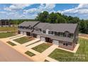 Aerial view of townhomes showcasing the community layout and landscaping at 5156 Tommy Ln # 1301, Stanley, NC 28164
