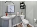 Modern half bathroom with pedestal sink and gray walls at 109 Watrous Way, Mooresville, NC 28115