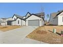 Two-story home with gray and white exterior, two-car garage, and landscaping at 148 Windy Dell Dr, Tega Cay, SC 29708