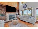 Spacious living room with stone fireplace, built-ins, and lake views at 49412 Wood Land Dr, Norwood, NC 28128