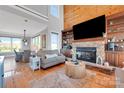 Open-concept living area with a cozy fireplace and built-in shelving at 49412 Wood Land Dr, Norwood, NC 28128