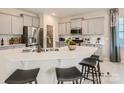 Modern kitchen with an island, gray cabinets, and white countertops at 1812 Otter Perch Ln, Fort Mill, SC 29715