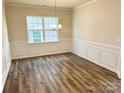 Formal dining room with wood flooring, wainscoting, and a chandelier at 1965 Copper Path Dr, Fort Mill, SC 29715