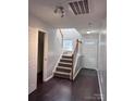 Bright entryway with staircase, dark hardwood floors, and coat closet at 229 Arlington Downs Blvd, Matthews, NC 28104