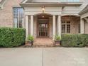 Elegant entryway with brick columns and a wood door at 4120 Cornwallis Camp Dr, Charlotte, NC 28226