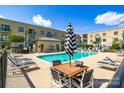 Relaxing community pool area with lounge chairs and tables at 721 Governor Morrison St # 425, Charlotte, NC 28211