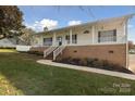 Two-story home with a large front porch and yard at 104 Vista Dr, Davidson, NC 28036