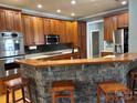 Modern kitchen with ample cabinetry, a breakfast bar, and stainless steel appliances at 1327 Moonshadow Ln, Shelby, NC 28150