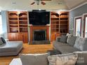 Spacious living room featuring a large built-in entertainment center and fireplace at 1327 Moonshadow Ln, Shelby, NC 28150