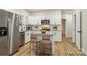 Modern kitchen with white cabinets, granite countertops, and stainless steel appliances at 1423 Roseland Dr, Lincolnton, NC 28092