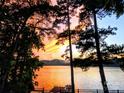 Stunning sunset over lake view from backyard at 228 Sugar Loaf Dr, Troy, NC 27371