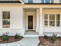 Inviting front porch with a dark brown door and white brick base at 3837 Bon Rea Dr, Charlotte, NC 28226