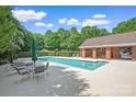 Community pool with lounge chairs and patio area at 7507 Hurstbourne Green Dr, Charlotte, NC 28277