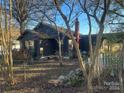 Dark-colored house with a chimney, surrounded by trees and a yard at 3217 Howe Dairy Rd, Gastonia, NC 28056