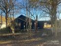 Dark-colored house with a chimney, surrounded by trees and a yard at 3217 Howe Dairy Rd, Gastonia, NC 28056