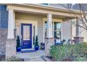 Inviting front porch with blue door, brick columns, and potted plants at 755 Kathy Dianne Dr, Indian Land, SC 29707