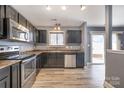 Modern kitchen with stainless steel appliances and dark wood cabinets at 8140 Haviland Ln, Fort Mill, SC 29707