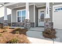 Front porch with stone columns and a white door at 1368 Cedardale Ln, Denver, NC 28037