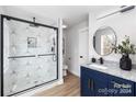 Stylish bathroom featuring a frameless shower and a navy blue vanity at 310 Town St, Landis, NC 28088