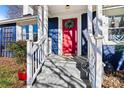 Inviting front entrance with red door, white railings, and a walkway at 1236 Mitchell Ave, Statesville, NC 28677