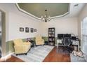 Bright dining room with hardwood floors, two armchairs, and built-in shelving at 6428 Hasley Woods Dr, Huntersville, NC 28078