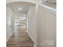 Bright entryway with hardwood floors, view to living area and kitchen at 8205 Stonemere Ln, Charlotte, NC 28215